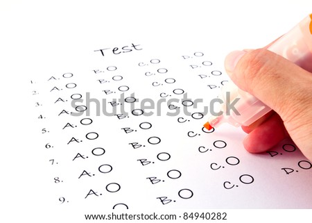 Hand on red pen choosing the test list on the examination