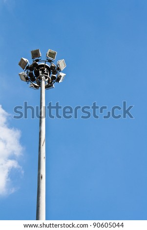 Spot-light tower in blue sky with cloud