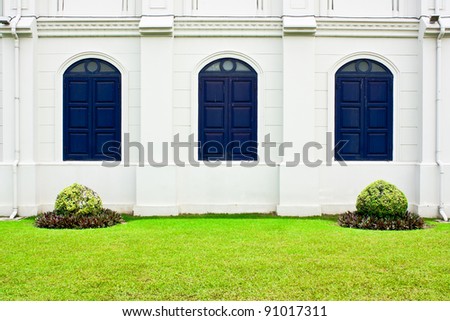 White wall with  Gothic  blue wood window