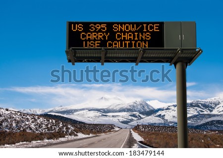 Road Conditions Sign:  A lighted message warns travelers to prepare for hazardous driving conditions on a Sierra Nevada mountain road.