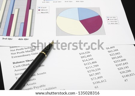 business financial chart analysis with pen on paper work