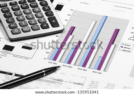 business financial chart analysis with pen & calculator on paper work