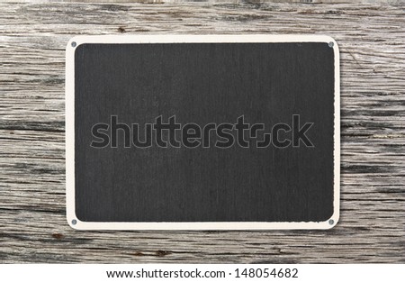 blank blackboard on old wooden plate background