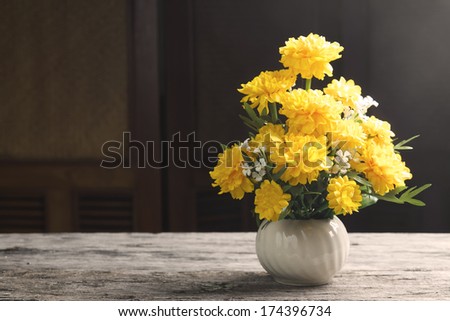 Marigold flower on old table, sepia feeling