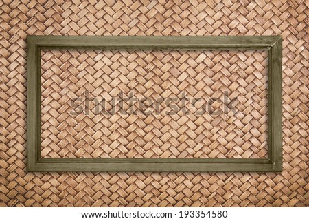 wide picture frame on rattan wall background