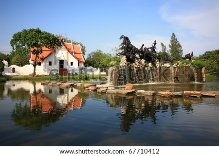 statue with temple on the lake at Thailand