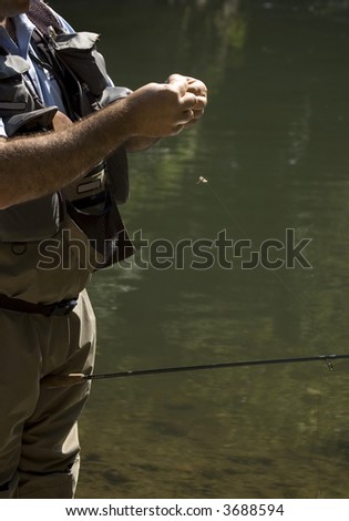 Fisherman preparing the bait or the fly