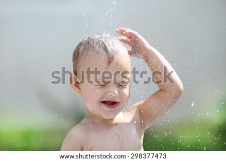 Portrait of a child playing with water.