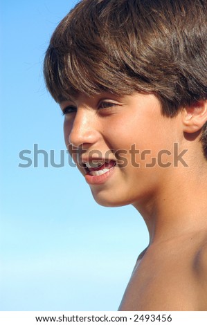 stock photo Closeup of happy teen boy on the beach