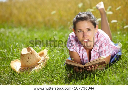 Happy attractive female read book, summer outdoor shoot