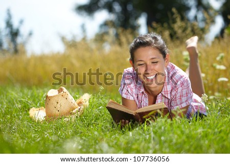 Happy attractive female read book, summer outdoor shoot