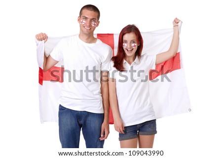 Happy couple with English flags on their cheeks holds big English flag, isolated on white