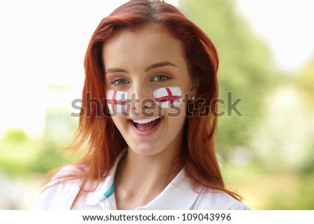 Happy female with English flags on her cheeks