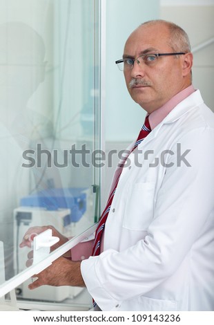 Mature male lab worker working on some project, lab shoot