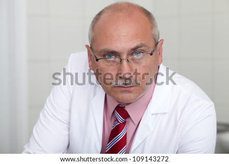 Mature male lab worker working on some project, lab shoot