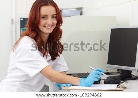 Young female lab technician works on some samples, lab shoot