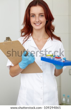 Young female lab technician works on some samples, lab shoot