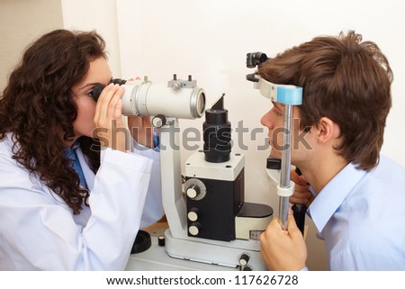 Optometrist performing visual field test
