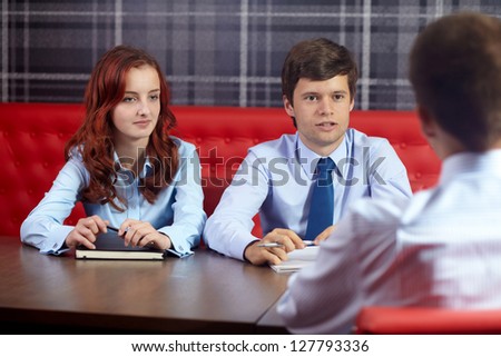Job interview, two young colleagues from hr department and applicant in the office
