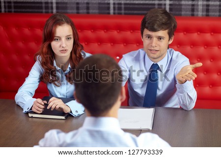 Job interview, two young colleagues from hr department and applicant in the office