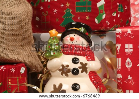 snowman with gifts around him