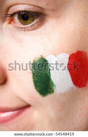 italian team supporter with flag painted on her cheek, studio shoot isolated on black background