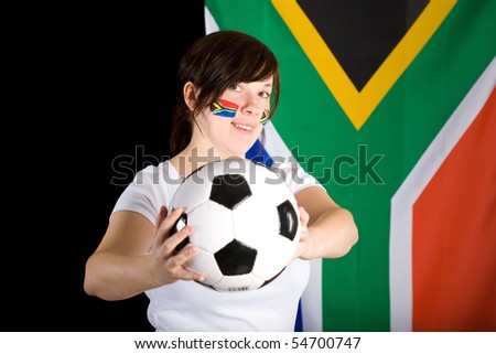 south africa world cup supporter, young female with flags on her cheeks and big south africa flag as background, studio shoot
