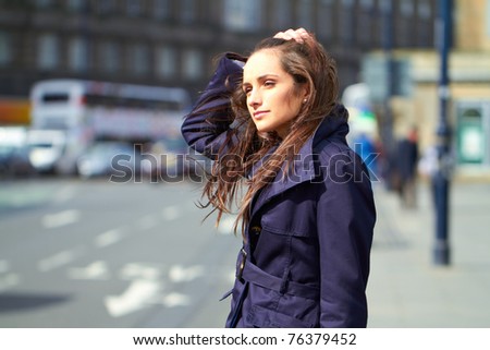 young attractive thoughtful female in city centre location, outdoor shoot
