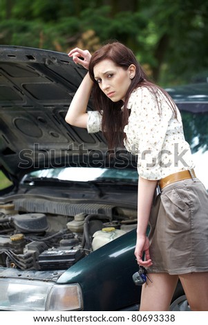 attractive brunette in front of her car broken down car, assistance concept