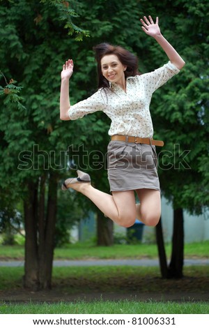 happy attractive brunette female jump up, park shoot