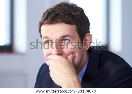 Young stressed and worried businessman, looking away, sad face expression.
