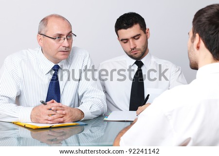 Senior and young colleague interview applicant for a job