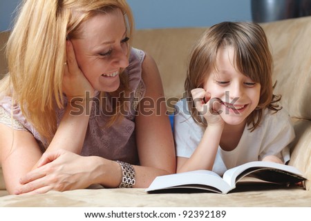 Young mother read book with her son