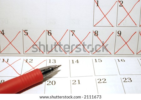 Calendar with dates crossed out in red pen