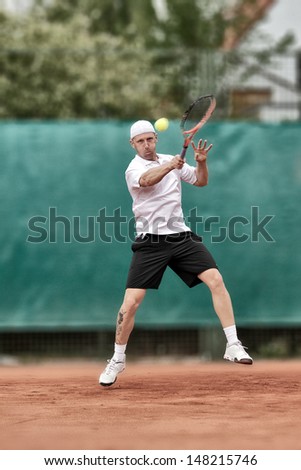 Tennis Player hitting hard Topspin Forehand