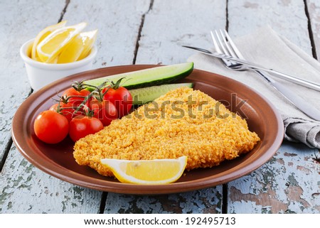 Breaded fish fillet with vegetables