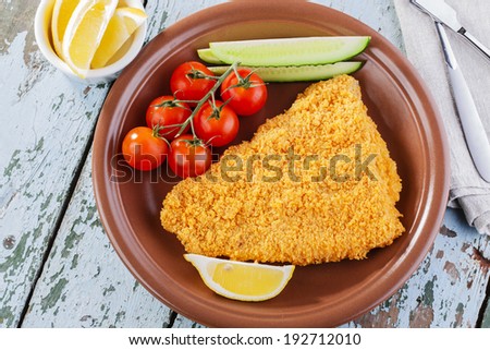 Breaded fish fillet with vegetables