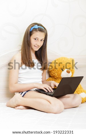 Girl ten eleven twelve years old typing on a computer