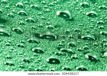 green water drops on the surface