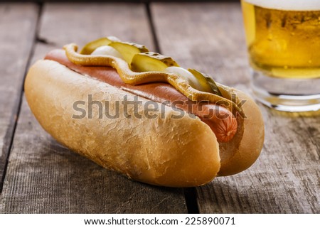 hot dog with mustard, pickles and onions