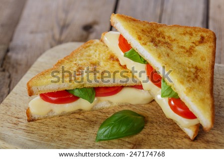 fried toast sandwich with mozzarella and cherry tomatoes