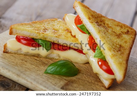 fried toast sandwich with mozzarella and cherry tomatoes