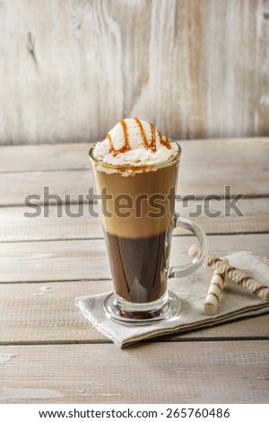 cold coffee with ice cream and caramel in a glass