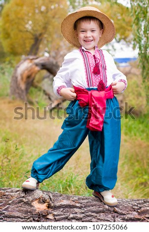 Cute child in traditional eastern european clothes outdoor