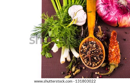 Various spices and herbs, onion and garlic isolated on white
