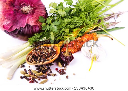 Various spices and herbs, onion and garlik isolated on white