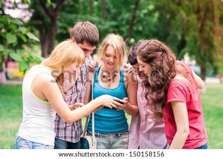 Group of happy smiling Teenage Students looking in tablet pc