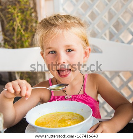 Cute child eating soup from the bowl, healthy food