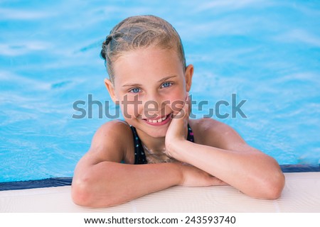 Cute little girl getting out of swimming pool