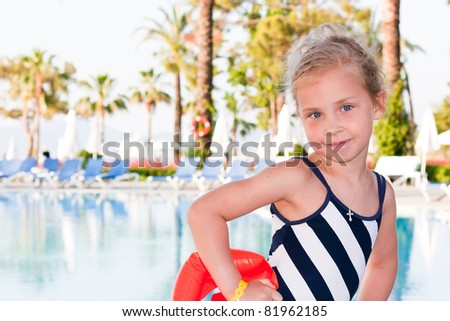 Beautiful girl posing at the swimming pool
